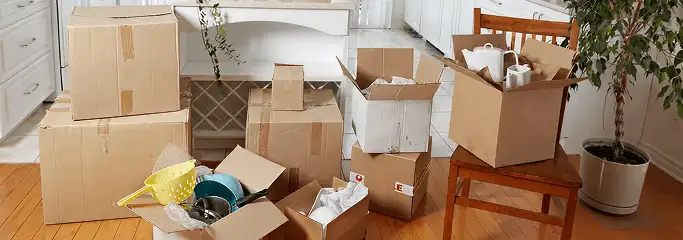 Packed moving boxes and household items in a kitchen before move-out or move-in cleaning, San Francisco, CA.